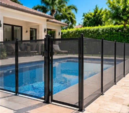 After: rectangular pool beside a covered patio with a black mesh removable pool fence