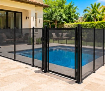 After: modern backyard pool with a travertine deck with a black mesh removable pool fence