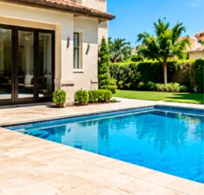 Before: modern backyard pool with a travertine deck without a fence